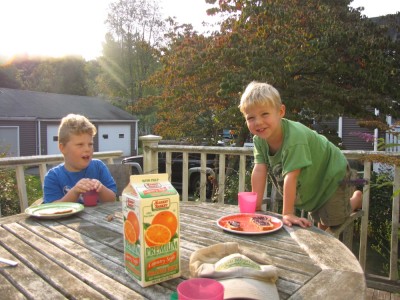 Harvey and Zion eating breakfast on the back porch