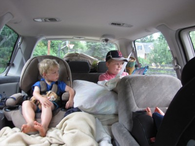 the boys in the car, watching a show before we even leave our street