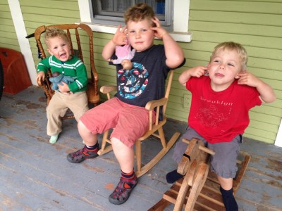 the boys sitting on the front porch making faces