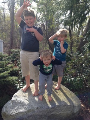 the boys standing on a rock striking a silly pose