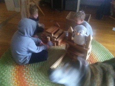 the boys playing with blocks and stuffed animals