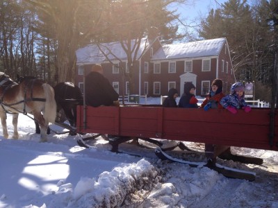 Leah and the boys with friends on a horse-drawn sleigh at Sturbridge