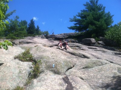 Harvey sliding down a steep rock face