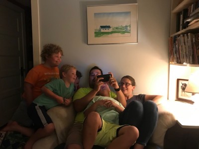 the kids watching a video on Samuel's phone at small group