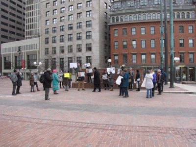 a small crowd protesting on City Hall Plaza