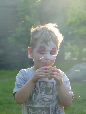 Lijah eating a smore in smoke and sparks