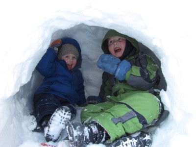 Zion and Harvey smiling in a snow cave