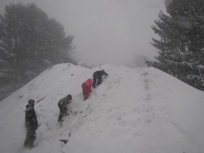 Harvey and friends climbing up a giant snow-covered pile of dirt
