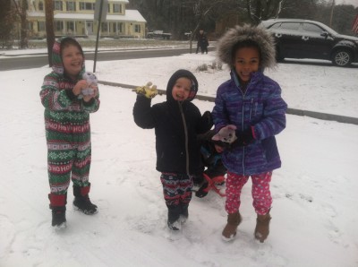 Harvey, Zion, and Nisia in the snow in their PJs