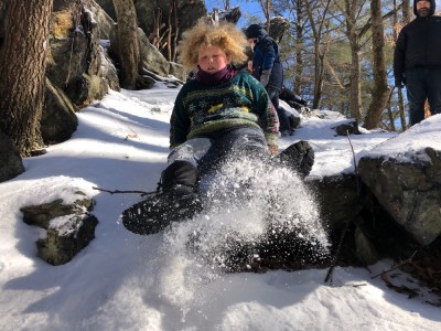 Harvey sliding on the snow between rocks