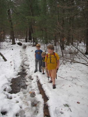 Harvey, Zion, and Nathan hiking in the snow--Harvey and Zion in shorts and sandals