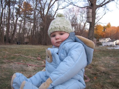 Harvey sitting outside in his snowsuit