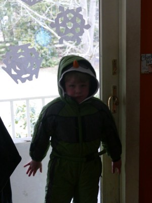 Zion in his snowsuit by the side door