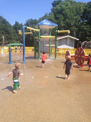 Zion, Lijah, and Julen running in the sprinkler park