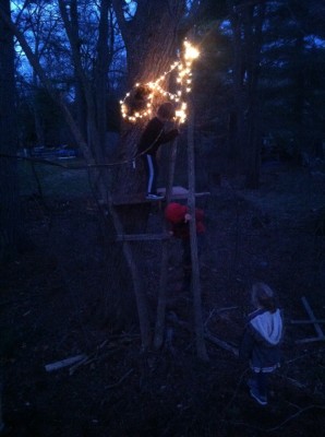 Harvey and two friends playing on a treehouse in the dark