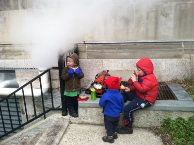 the boys having a picnic by a steam vent outside the Arlington library