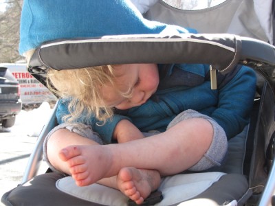 Lijah sleeping leaning forward in the stroller
