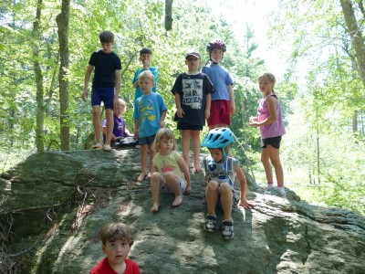 kids posing atop a rock