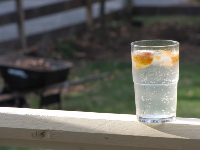 fizzy water with orange lime in the porch sun