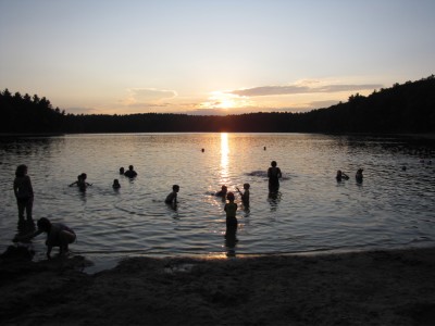 swimming in Walden Pond at sunset
