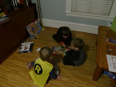 Lijah, Henry, and Liam playing a board game