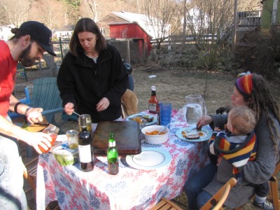 the table outside with food, tablecloth, Luke, Bridget, Mama, and Lijah