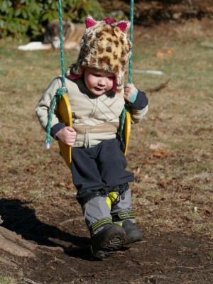 Lijah on the swing in his cat hat