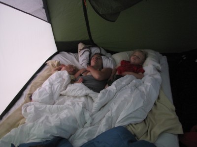 Lijah, Mama, and Zion sleeping on the air mattress in the tent