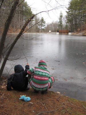 the boys testing the ice on the pond