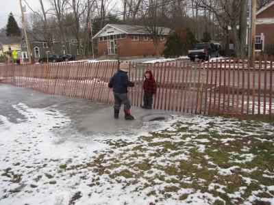 Harvey and Zion sliding on the overflow off to the side of the rink