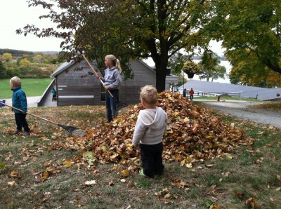 Lijah watching the big kids make a leaf pile