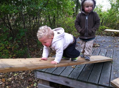 Lijah climbing up a board on our home-made obstacle course