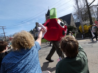 Harvey getting a high-five from a walking tomato at the parade