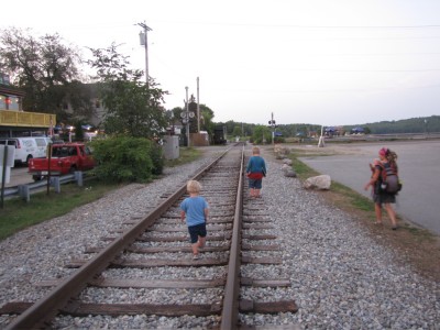 Mama and the boys walking along the train tracks