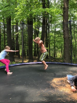 Zion and a friend jumping on a trampoline