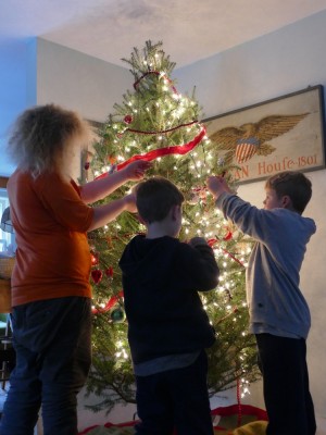 the boys decorating the Christmas tree