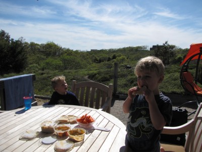 Zion and Lijah eating appetizers at the deck table