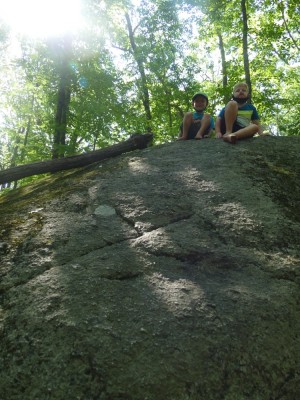 Zion and Elijah atop a big rock