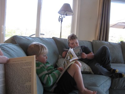 Zion and Harvey reading on the couch