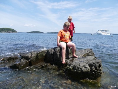Harvey and Zion on a wave-beset rock in Bar Harbor