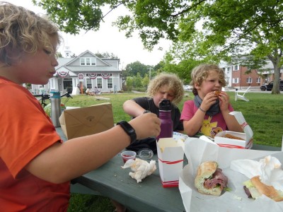the boys eating at a picnic table outside the Lexington visitor center
