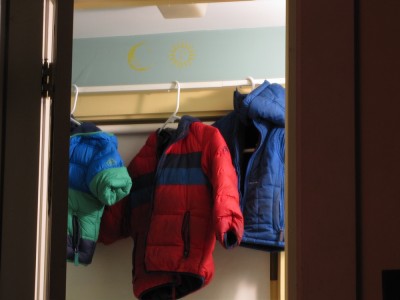 the boys' three coats hanging in the bathroom after the wet snow