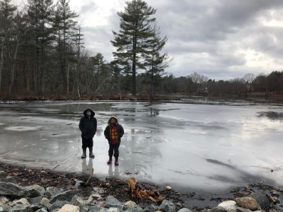 Zion and Lijah standing on the puddley ice on the edge of Fawn Lake