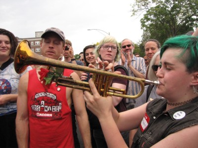 a trumpet player amidst the crowd
