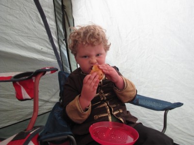 Harvey eating a bagel in the tent porch
