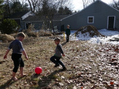 Harvey, Zion, and Nathan playing soccer in Nathan\'s backyard