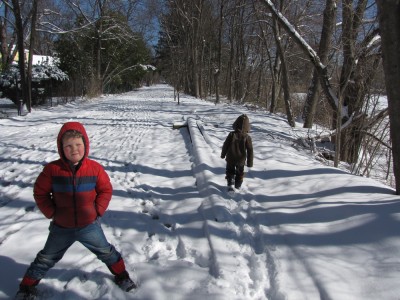 the boys walking along the snowy bike path