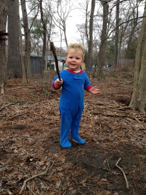 Lijah playing in the woods in his footie pajamas