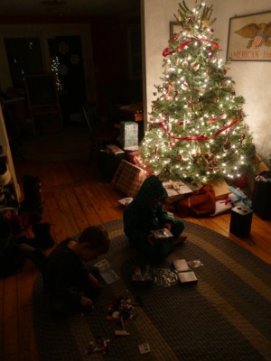 Zion and Lijah building legos by the light of the Christmas tree