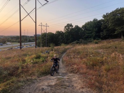 Zion biking up a hill at sunrise
